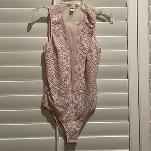 Victoria’s Secret used sheer bodysuit. Labeled a size large.